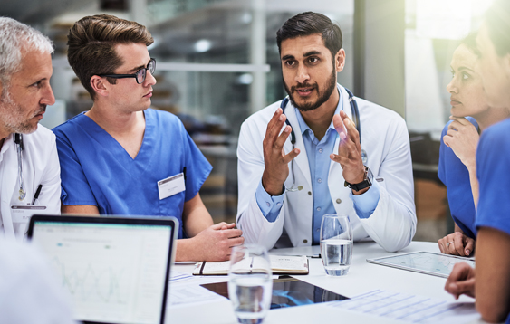 Image of doctors having a meeting around a table.